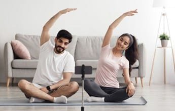 Couple learning Fertility Yoga for achieving natural pregnancy