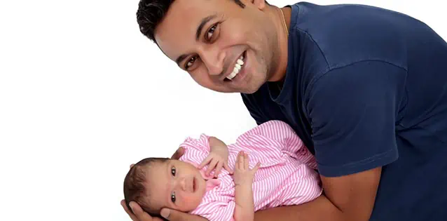 Kunal Chatterjee holding his baby after successful IVF